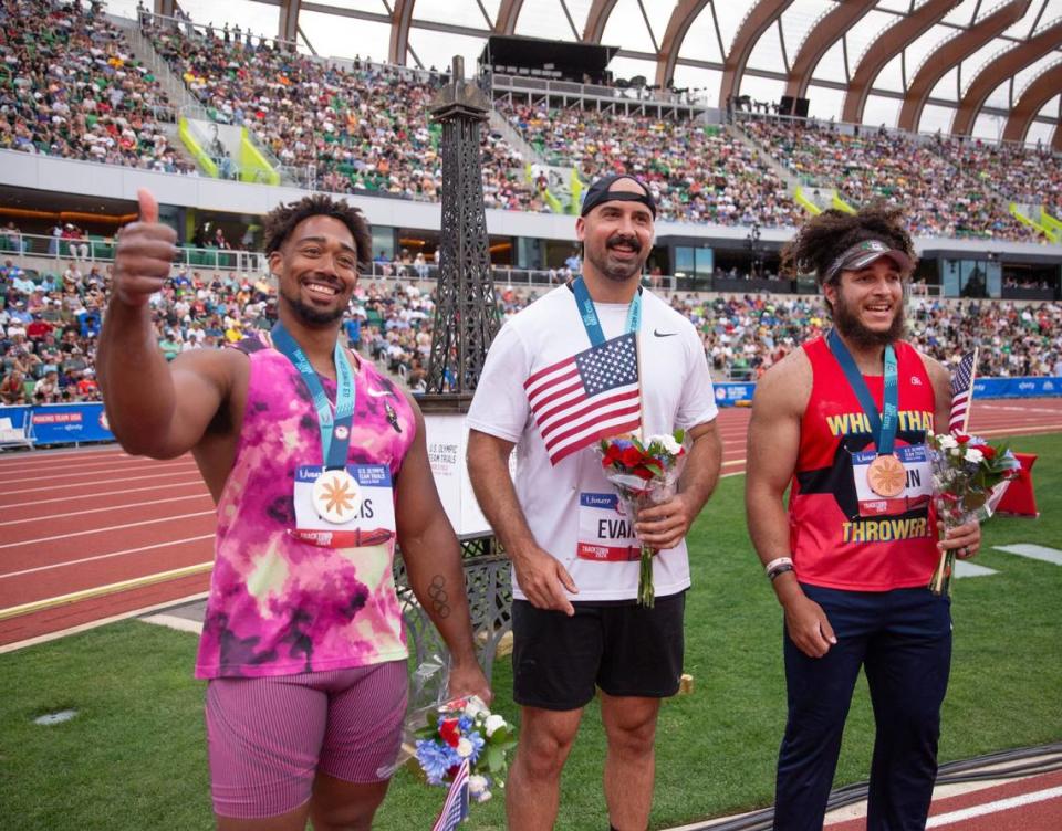 Silver medalist Sam Mattis, left, joins champion Andrew Evans and bronze medalist Joseph Brown in celebrating their discus finishes at the U.S. Olympic Team Trials at Hayward Field in Eugene, Oregon, on Saturday.