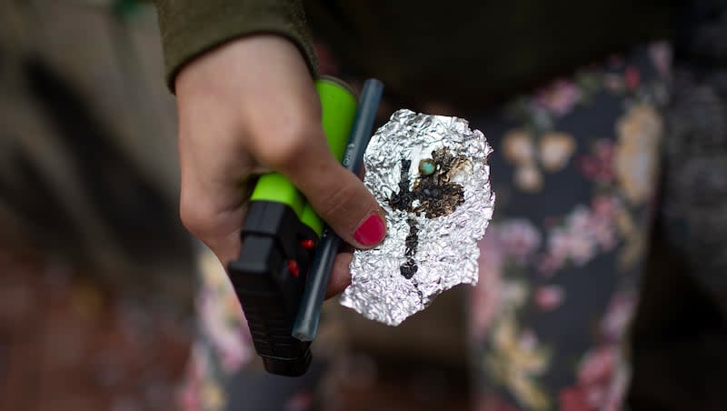 A person holds drug paraphernalia near the Washington Center building on SW Washington Street, April 4, 2023, in downtown Portland, Ore. A bill recriminalizing the possession of small amounts of drugs was passed by the Oregon Legislature, Friday, March 1, 2024, undoing a key part of the state’s first-in-the-nation drug decriminalization law as governments struggle to respond to the deadliest overdose crisis in U.S. history.