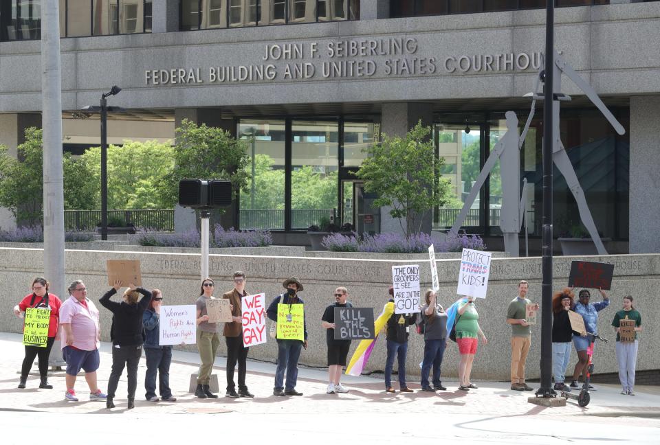 Democratic Socialists of America members hold a Kill the Bills rally Sunday at the Federal Building in downtown Akron.