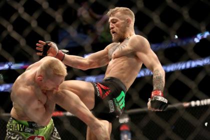 Conor McGregor, of Ireland, lands a knee against Dennis Siver, of Germany, during their featherweight fight at UFC Fight Night, Sunday, Jan. 18, 2015 in Boston. McGregor won via 2nd round TKO. (AP Photo/Gregory Payan)