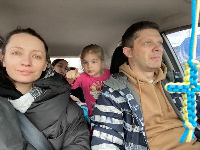 A picture of Vitaliy Georgiev and his family inside a vehicle.