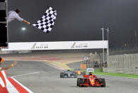 Formula 1 F1 - Bahrain Grand Prix - Bahrain International Circuit, Sakhir, Bahrain - April 8, 2018. Ferrari's German driver Sebastian Vettel crosses the finish line to win the Bahrain Formula One Grand Prix at the Sakhir circuit in Manama on April 8, 2018. Giuseppe Cacace/Pool via REUTERS