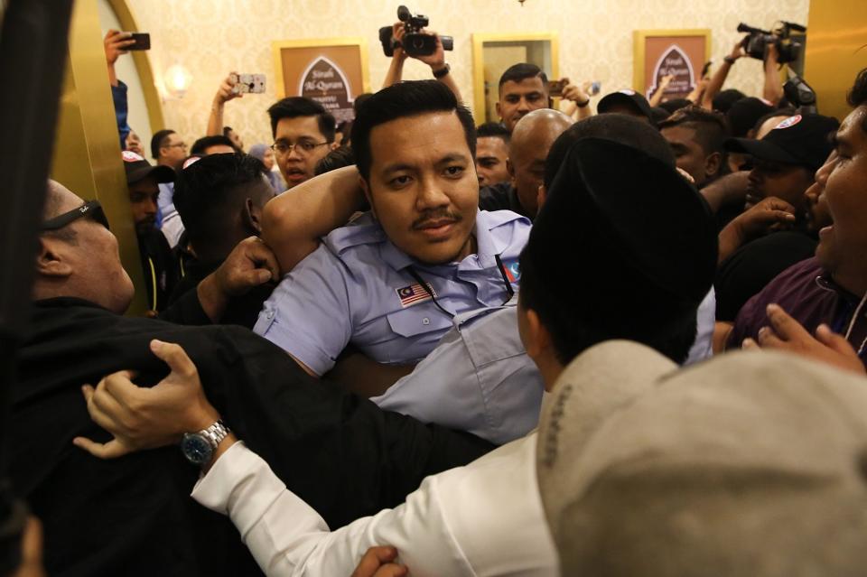 PKR Youth security personnel (dressed in black) clash with Dr Afif Bahardin and a few others outside the Classic Ballroom at MITC in Melaka December 6, 2019. — Picture by Yusof Mat Isa