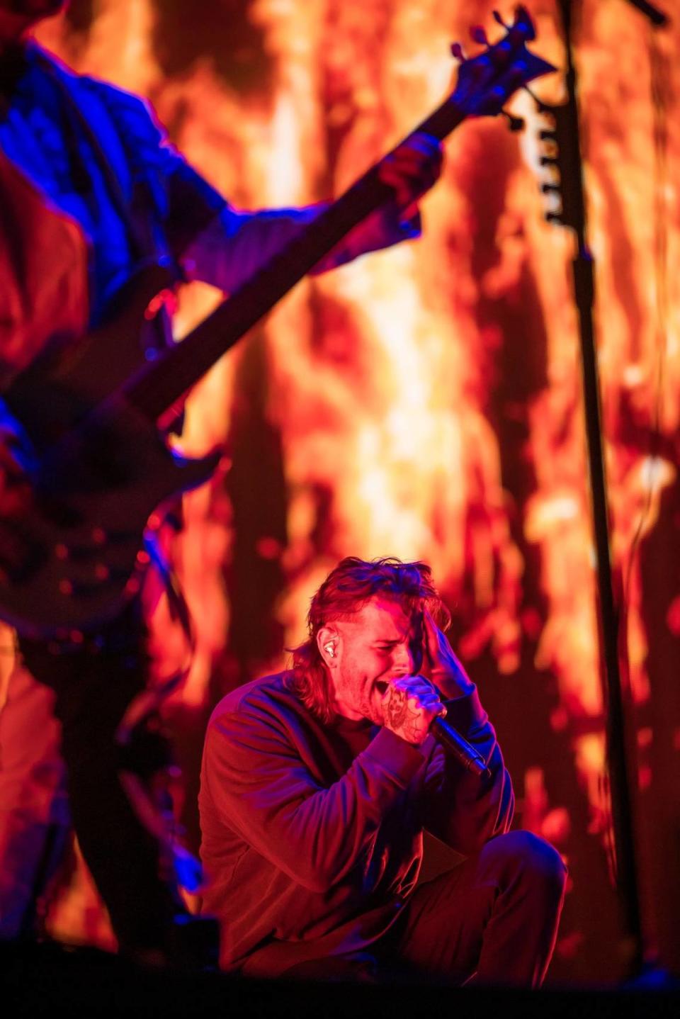 M. Shadows, lead vocalist of Avenged Sevenfold, kneels as he sings on the first day of Aftershock music festival on Thursday.