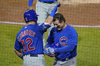 Chicago Cubs' Anthony Rizzo, right, celebrates with Kyle Schwarber (12) as he returns to the dugout after hitting a two-run home run off Pittsburgh Pirates relief pitcher Sam Howard during the eighth inning of a baseball game in Pittsburgh, Tuesday, Sept. 22, 2020. (AP Photo/Gene J. Puskar)