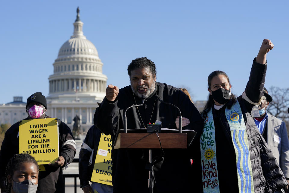 FILE - Rev. William Barber, center, co-chair of the Poor People's Campaign, speaks during a rally to press Congress to pass voting rights protections and the "Build Back Better Act," Monday, Dec. 13, 2021, in Washington.Barber was escorted by police out of a North Carolina movie theater, Tuesday, Dec. 26, 2023, after he insisted on using his own chair for medical reasons, prompting an apology from the nation's largest movie theater chain. (AP Photo/Patrick Semansky, File)