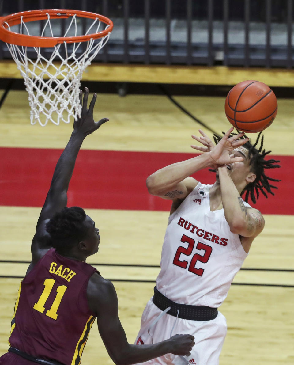 Rutgers guard Caleb McConnell (22) loses the ball as Minnesota guard Both Gach (11) defends during the first half of an NCAA college basketball game Thursday, Feb. 4, 2021, in Piscataway, N.J. (Andrew Mills/NJ Advance Media via AP)