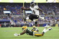 FILE - In this Aug. 15, 2019, file photo, Baltimore Ravens quarterback Lamar Jackson (8) leaps over Green Bay Packers cornerback Jaire Alexander (23) during the first half of a NFL football preseason game in Baltimore. The Ravens won last year with defense and behind the arm, and mostly legs, of rookie quarterback Lamar Jackson. (AP Photo/Gail Burton, File)