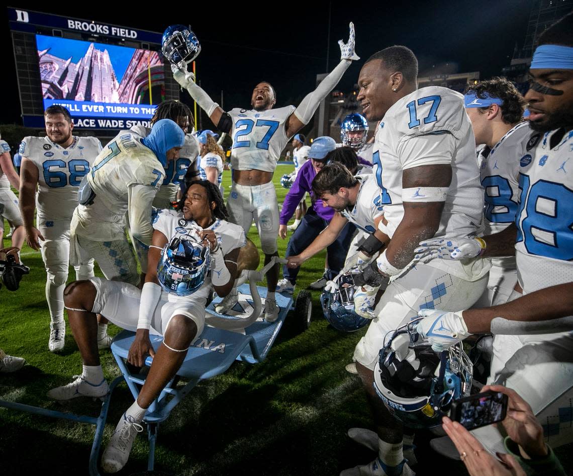 North Carolina’s Giovanni Biggers  (27) celebrates with the victory bell and his teammates after their 38-35 victory over Duke on Saturday, October 15, 2022 at Wallace-Wade Stadium in Durham, N.C.