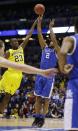 Kentucky's Aaron Harrison (2) shoots a three-point basket past Michigan's Caris LeVert (23) in the final second of the second half of an NCAA Midwest Regional final college basketball tournament game Sunday, March 30, 2014, in Indianapolis. Kentucky won 75-72. (AP Photo/David J. Phillip)