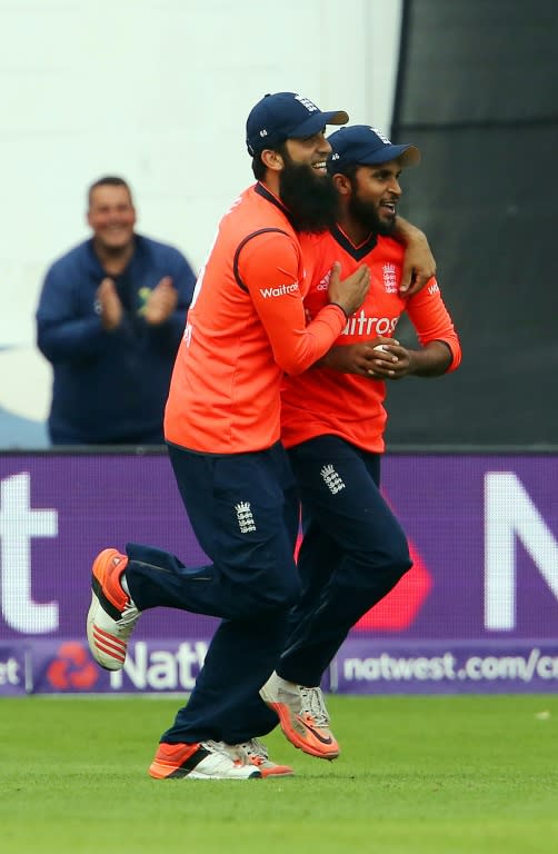 England's Moeen Ali (L) congratulates Adil Rashid after he takes the catch to dismiss Australia's Nathan Coulter-Nile during the Twenty20 International match in Cardiff on August 31, 2015