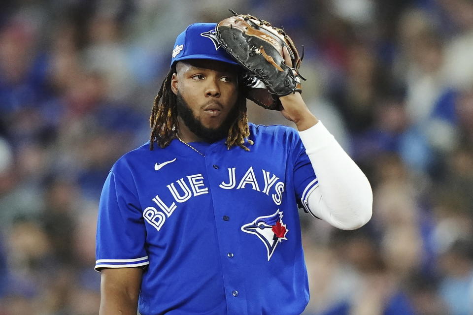 Toronto Blue Jays first baseman Vladimir Guerrero Jr. listens to the pitch call during the seventh inning against the Seattle Mariners in Game 1 of a baseball AL wild-card series, Friday, Oct. 7, 2022, in Toronto. (Nathan Denette/The Canadian Press via AP)