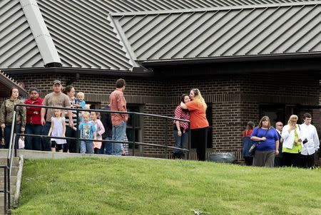 Mourners hug after the funeral service for six members of the Rhoden family, who were shot to death in rural Pike County on April 22, at Dry Run Church of Christ in West Portsmouth, Ohio, U.S. May 3, 2016. REUTERS/Kyle Grillot