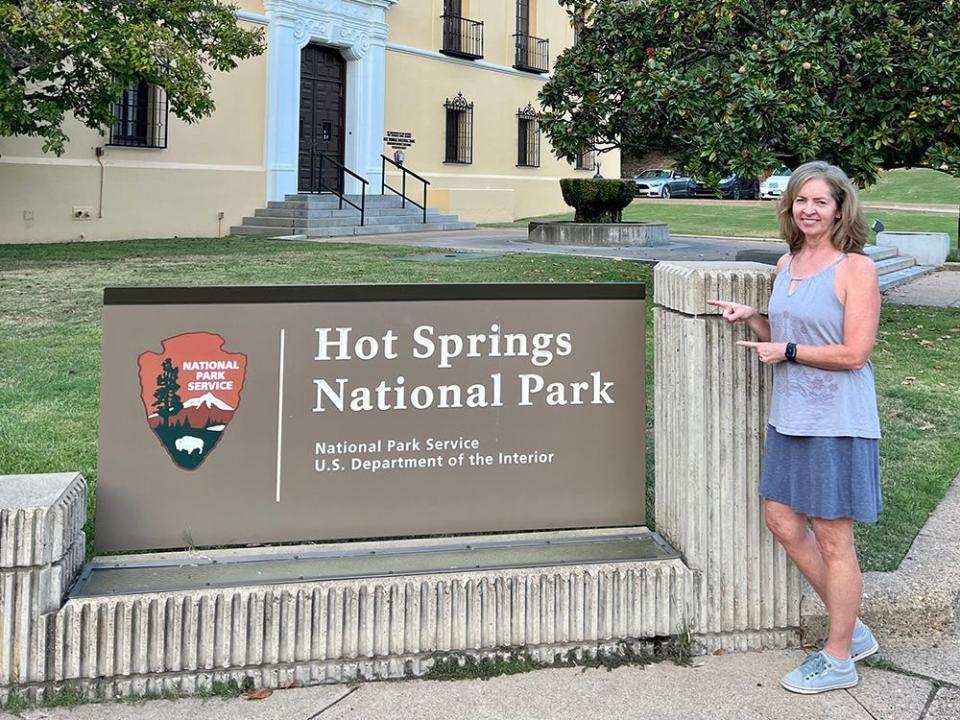 Kara points to the Hot Springs National Park sign