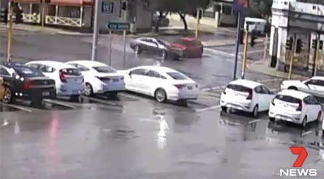 The blue car clips the red sedan as it races through an intersection. Source: 7 News