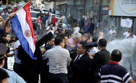 President of Paraguay’s congress Roberto Acevedo (C) is seen during a demonstration against a possible change in the law to allow for presidential re-election in front of the Congress building in Asuncion, Paraguay, March 31, 2017. REUTERS/Jorge Adorno