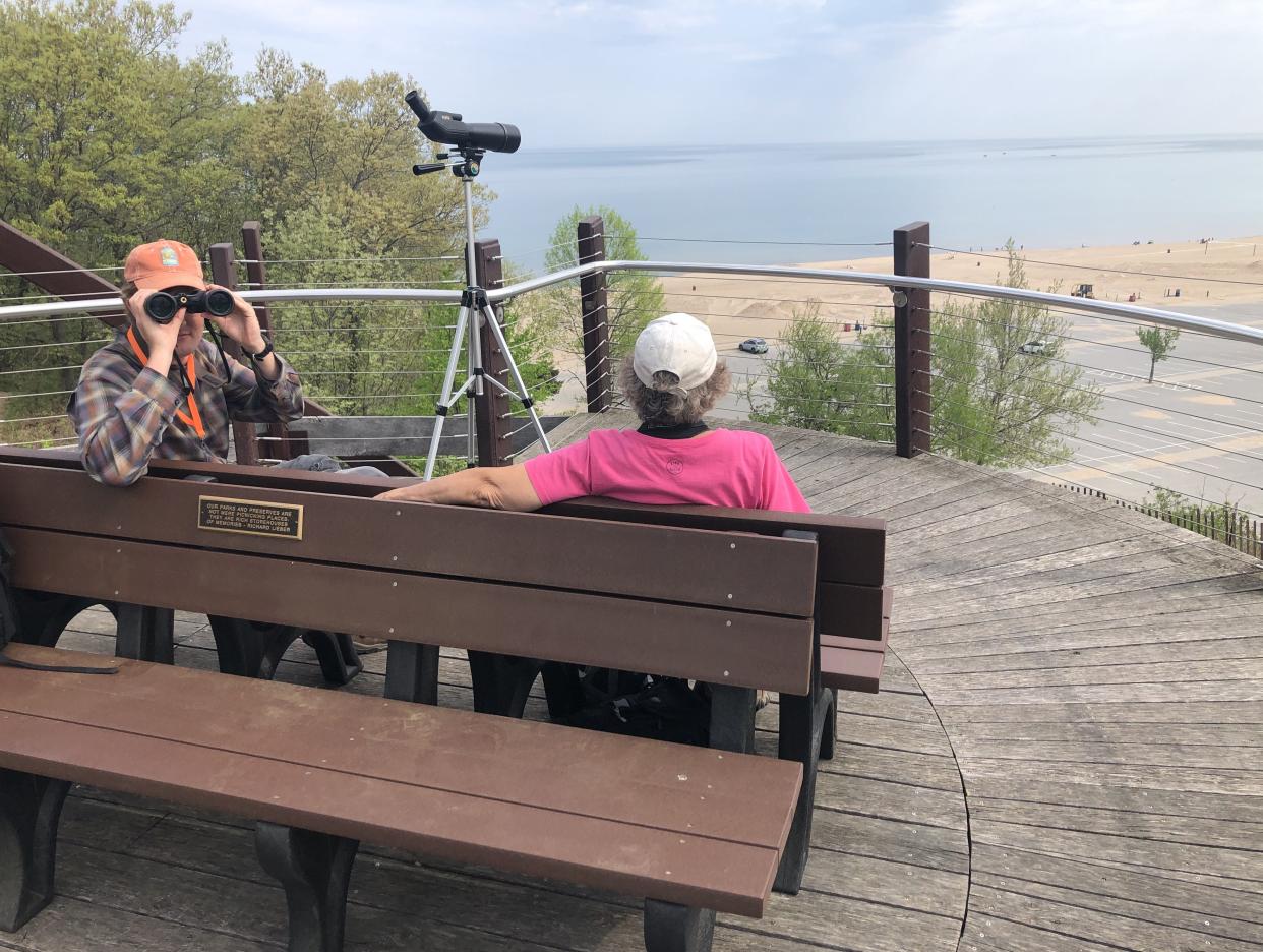Seasoned bird watchers scan the horizon and count migrating birds from the Longshore Platform at Indiana Dunes State Park during 2022's Indiana Dunes Birding Festival.
