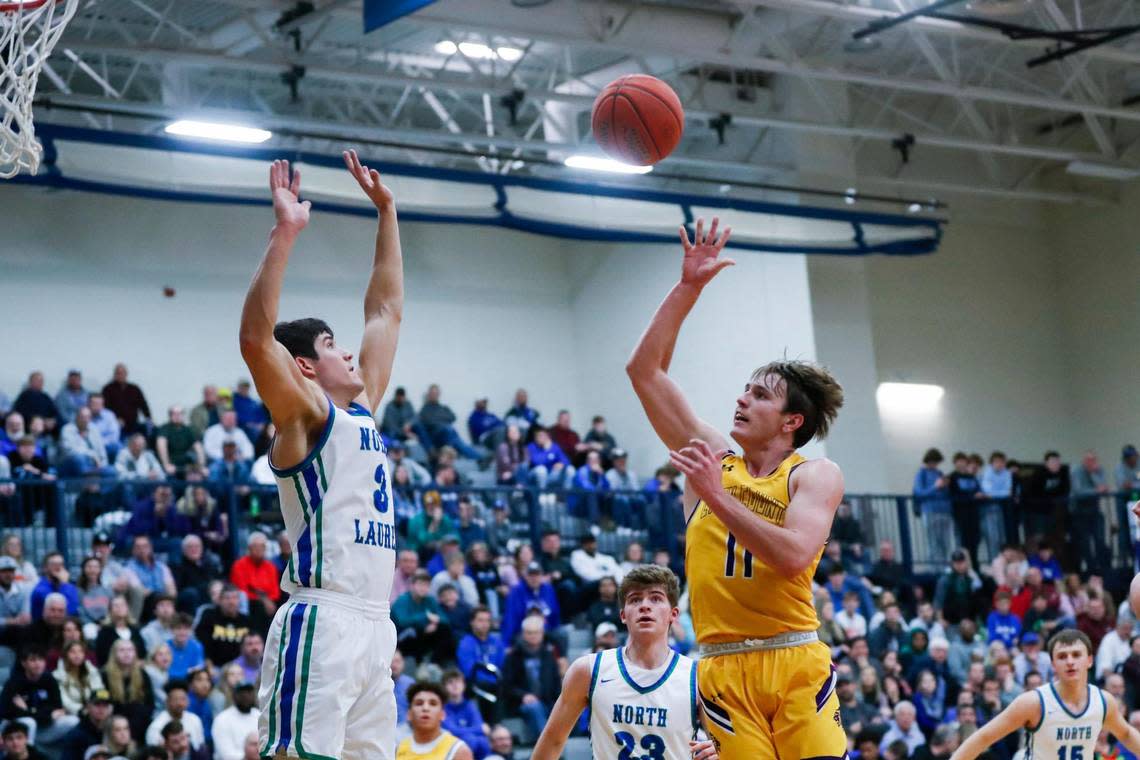 Lyon County’s Travis Perry (11) shot over North Laurel’s Reed Sheppard (3) during their game at Lexington Catholic High School on Saturday. Perry scored 45 points in the Lyons’ 90-83 win. Sheppard had 32 points.