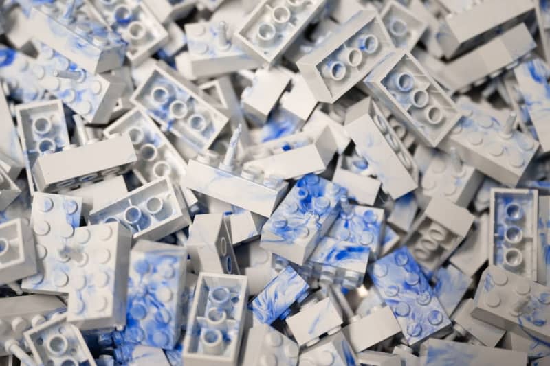 Clamping bricks lie in a container at an injection molding machine at the Dresden-based recycling start-up HolyPoly. Sebastian Kahnert/dpa