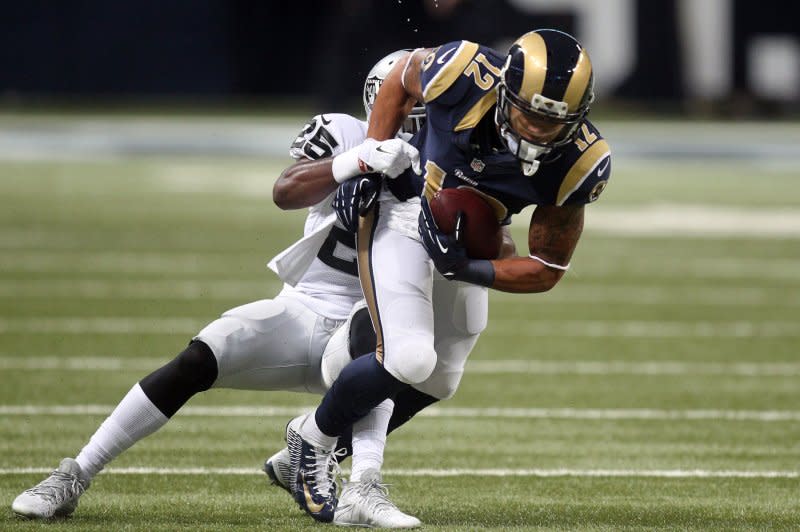 St. Louis Rams Stedman Bailey runs for a 12 yard gain as Oakland Raiders D.J. Hayden tries to drag him down in the first quarter at the Edward Jones Dome in St. Louis on November 30, 2014. St. Louis defeated Oakland 52-0. UPI/Bill Greenblatt