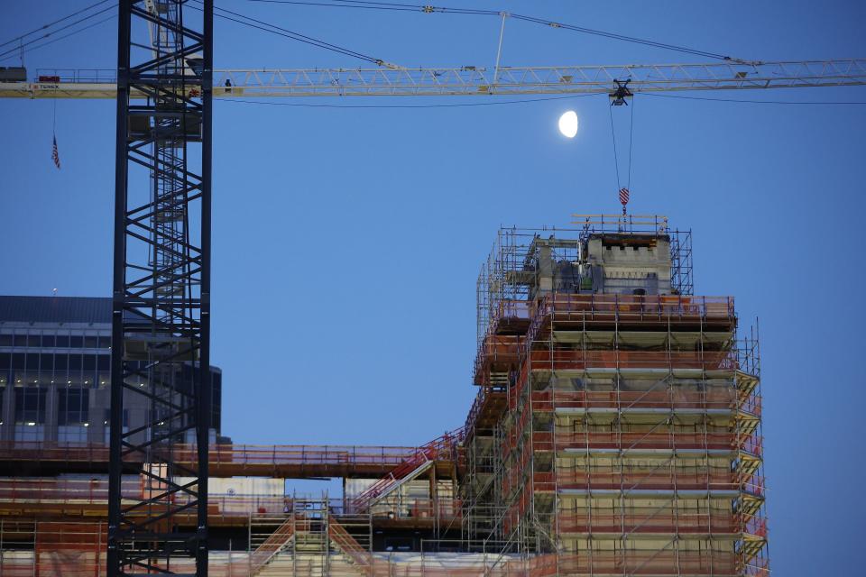 The moon shines on Temple Square as concrete is poured at the Salt Lake Utah Temple.