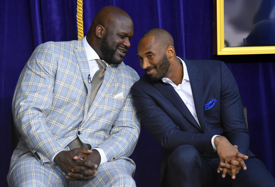 In this March 24, 2017, file photo, Shaquille O'Neal, left, and Kobe Bryant chat at the unveiling of a statue of O'Neal in front of the Staples Center in Los Angeles. Bryant downplayed talk of a reignited feud with Shaquille O'Neal, saying there is "nothing new" that has been said recently between the former teammates. Bryant had recently said that if O'Neal had worked harder, they could have won 12 rings together with the Los Angeles Lakers. O'Neal fired back on social media that they could have won more if Bryant had passed him the ball more often. But Bryant said Thursday, Aug. 29, 2019, during a visit to the U.S. Open tennis tournament that the comments don't mean they are fighting again. (AP Photo/Mark J. Terrill, File)