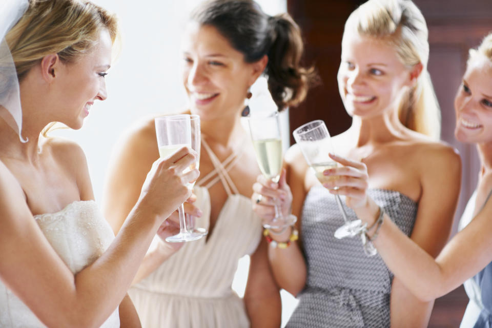 Bride cheersing with bridesmaids