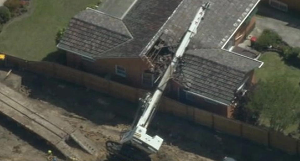 Elderly couple's near miss after construction crane crushes roof of Melbourne home