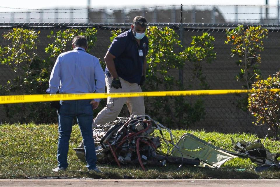 First responders look through debris from an accident scene after a small plane crashed near the 1300 block of Southwest 72nd Avenue in Pembroke Pines, Florida, on Monday, March 15, 2021. Two people died in the plane crash, and two others were taken to Hollywood’s Memorial Regional Hospital in serious condition, according to city fire-rescue. One of them, a 4-year-old boy, later died.