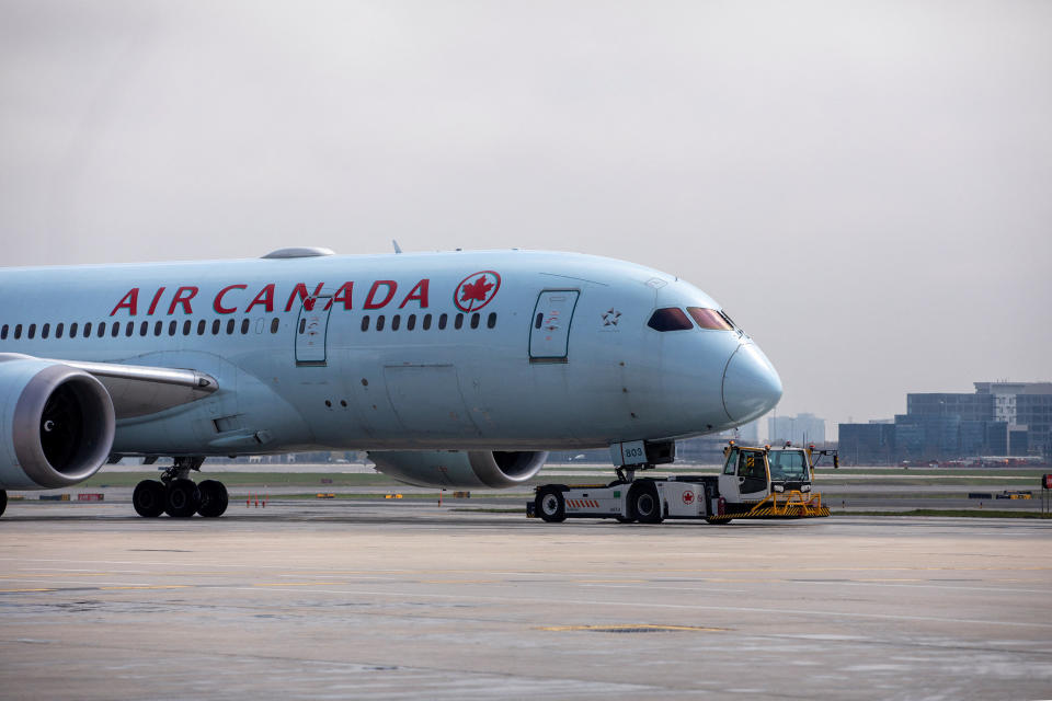 FILE PHOTO: An Air Canada airplane is towed along a runway at Toronto Pearson Airport in Mississauga, Ontario, Canada April 28, 2021. REUTERS/Carlos Osorio/File Photo