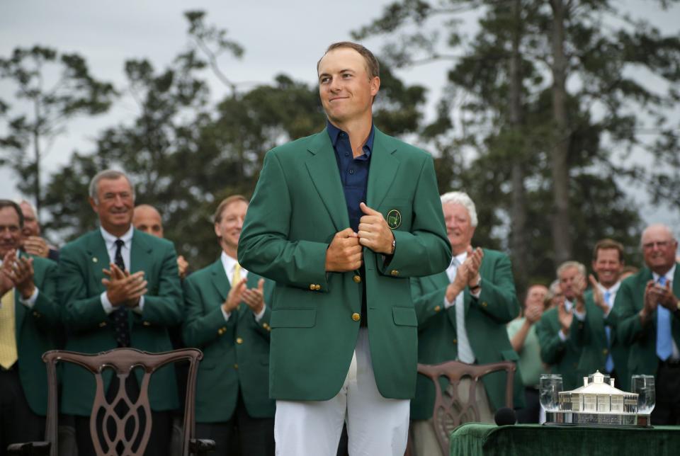 Jordan Spieth of the U.S. grins as he wears his Champion's green jacket on the putting green after winning the Masters golf tournament at the Augusta National Golf Course in Augusta, Georgia April 12, 2015. REUTERS/Brian Snyder