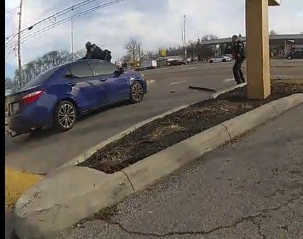 Body camera footage shows a car that struck a Columbus police sergeant driving with the officer on the car's hood. The driver, Holly Graham, is charged with felonious assault on a police officer.