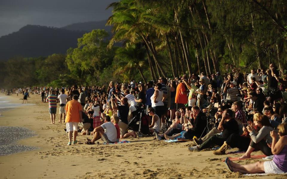 Spectators line the beach to view the total solar eclipse.