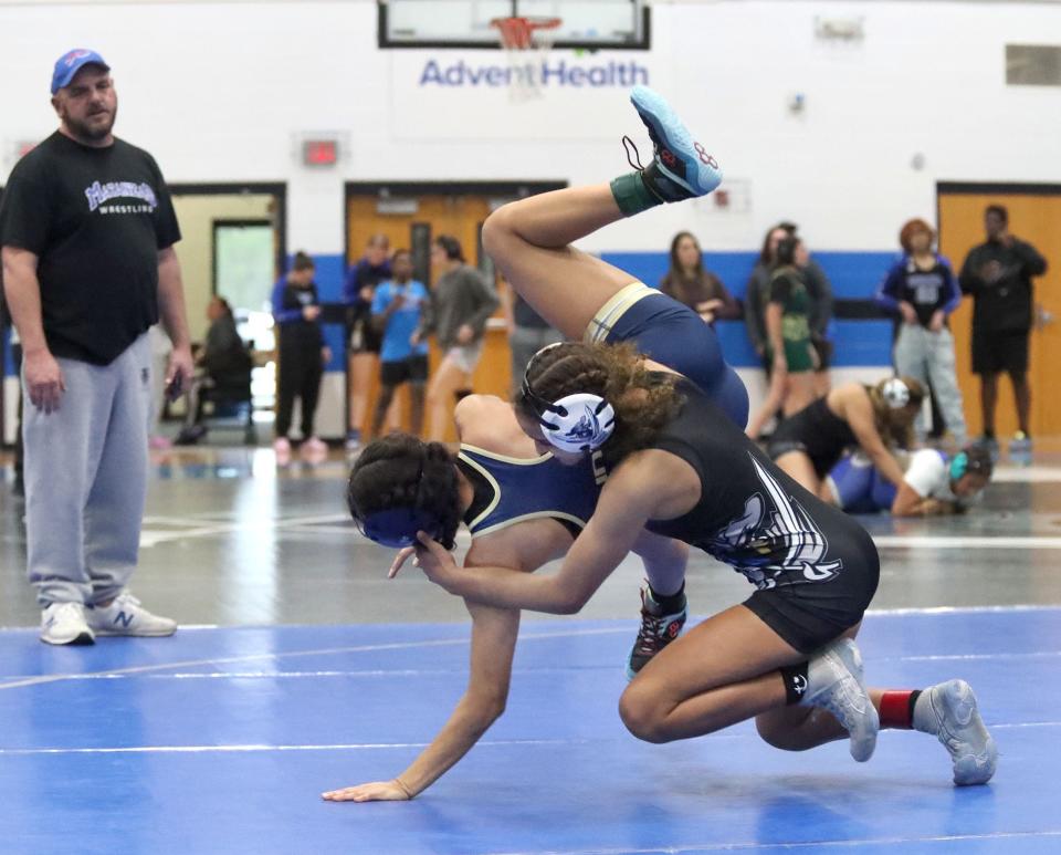 Matanzas' Mariah Mills takes Sandalwood's Aniella Garcia-Lopez off her feet, Thursday, Jan. 18, 2024 during the Pat White Memorial girls wrestling event at Matanzas High School in Palm Coast.