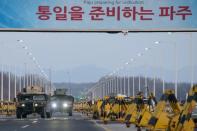 Military humvees pass through the Tongil bridge, a checkpoint leading to the Kaesong joint industrial zone, in Paju on February 11, 2016