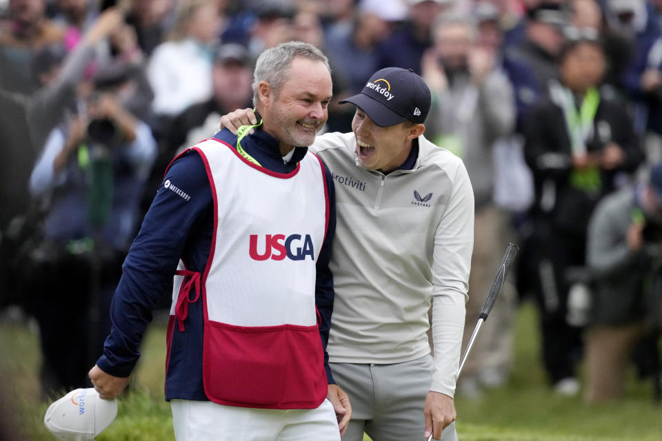 Matthew Fitzpatrick, of England, celebrates with his caddie after winning the U.S. Open golf tournament at The Country Club, Sunday, June 19, 2022, in Brookline, Mass. (AP Photo/Charlie Riedel)