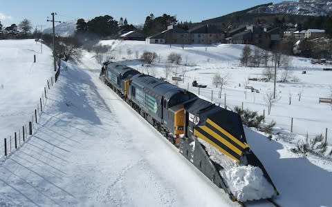 A fleet of de-icing trains were deployed to keep passenger services moving - Credit: Network Rail/PA