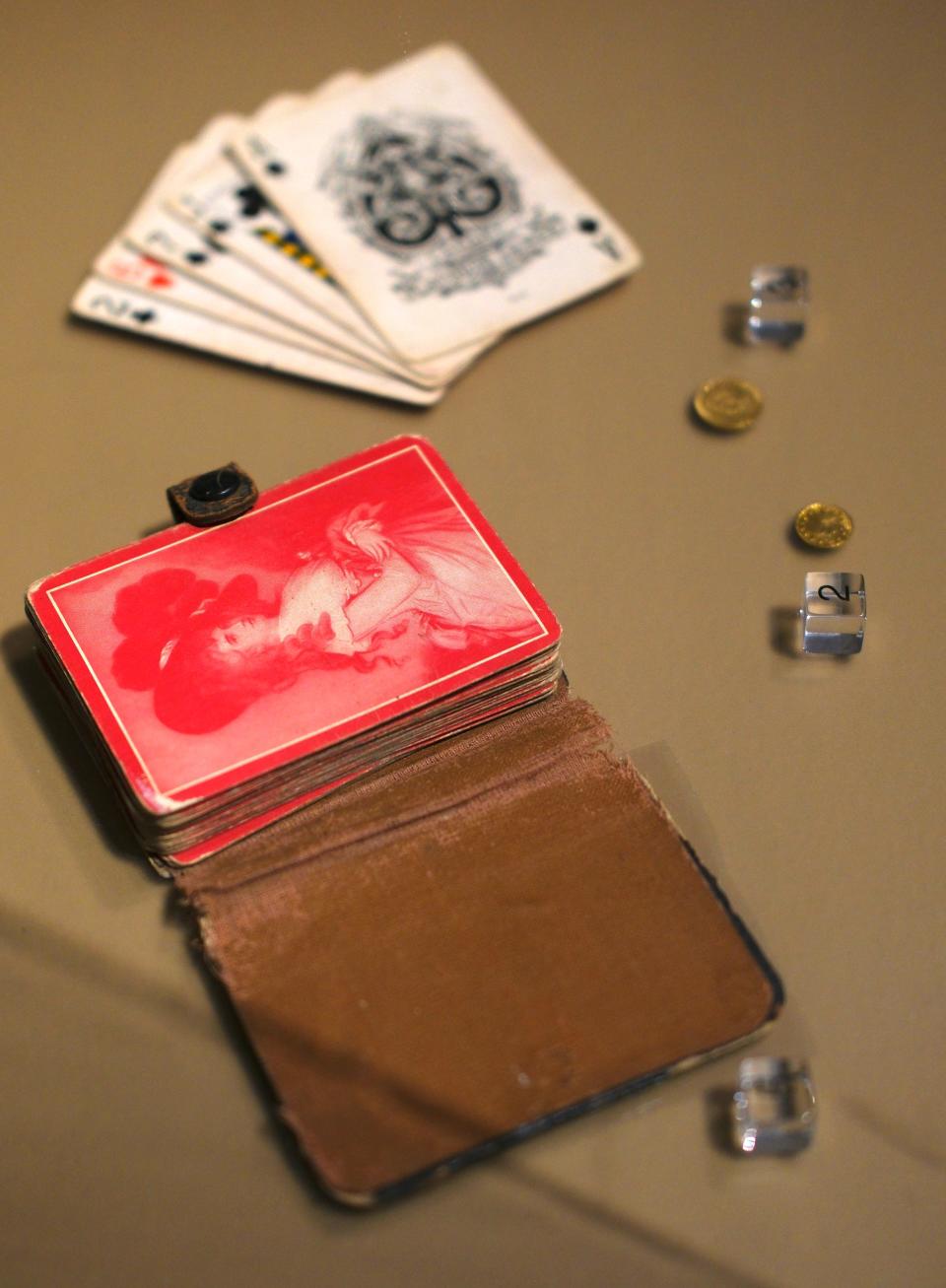 Playing cards with a case from 1850 and coins from 1854 and 1874 are on view in the National Cowboy & Western Heritage Museum's exhibition "Treasures from our Atherton Vault."