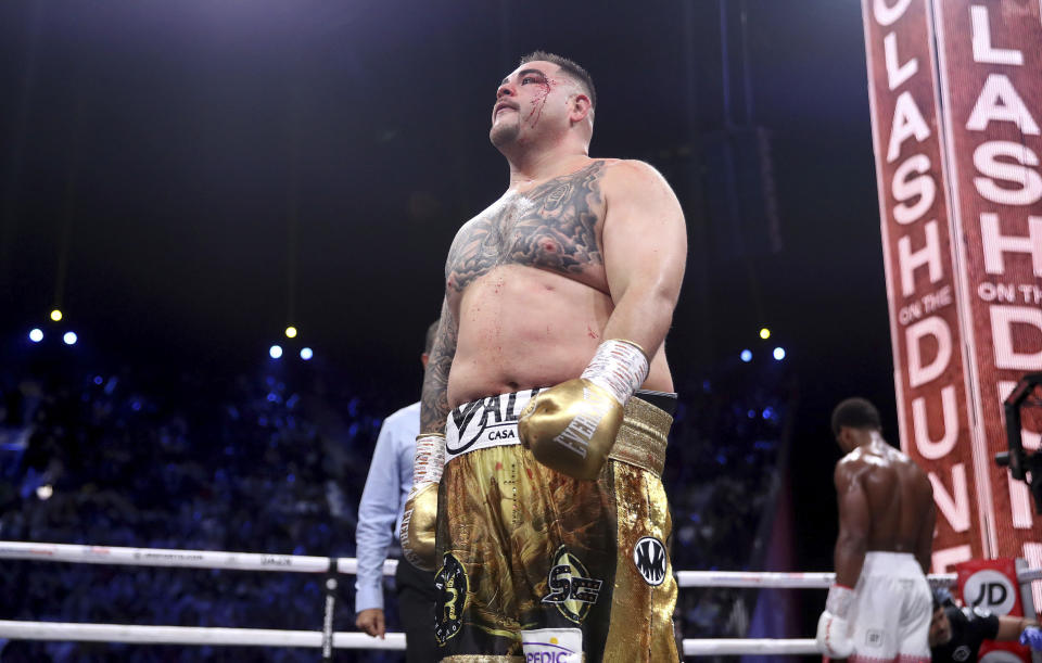 Defending champion Andy Ruiz Jr., left, walks back to his corner at the end of a round after getting cut during his fight against Britain's Anthony Joshua in their World Heavyweight Championship contest at the Diriyah Arena, Riyadh, Saudi Arabia. (Nick Potts/PA via AP)