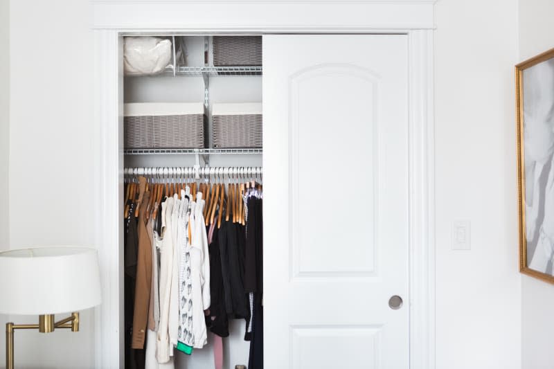 Bedroom closet with one door open to reveal interior