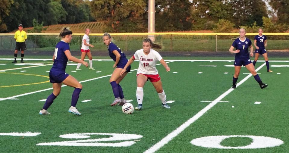 Fairfield Union junior Claire Brown keeps the ball away from a pair of Bloom-Carroll defenders during Saturday's Mid-State League-Buckeye Division game at Bloom-Carroll's Carl Fell Stadium. The two teams battled to a 2-2 tie.