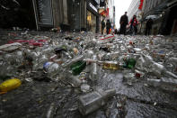 <p>Carnival revellers walk on empty alcohol bottles during “Weiberfastnacht” (Women’s Carnival) in Cologne, Germany on Feb. 23, 2017, marking the start of a week of street festivals with the highlight “Rosenmontag”, Rose Monday processions. (Photo: Wolfgang Rattay/Reuters) </p>