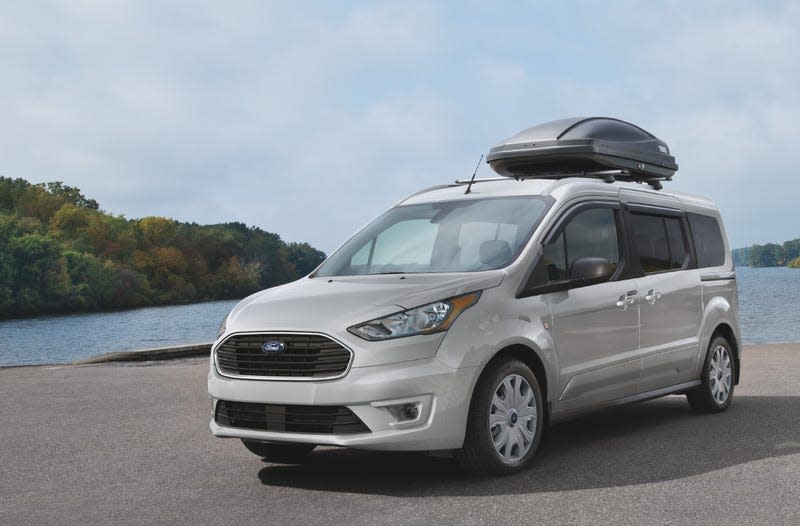 A Ford Transit Connect parked by a lake