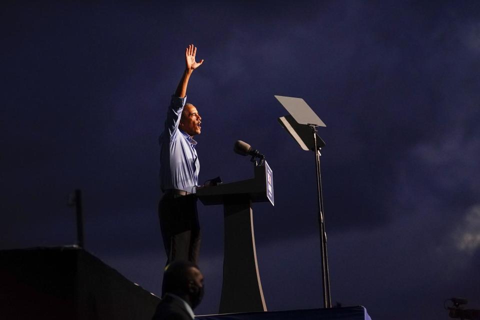 Obama waves after speaking at the election rally as he campaigns for Joe Biden (AP)