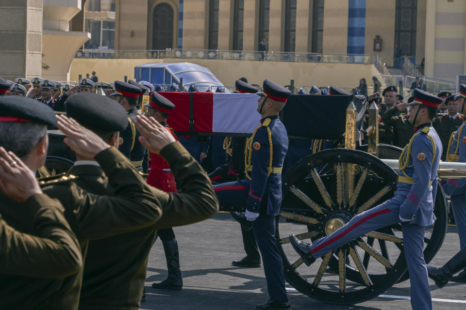 A horse-drawn carriage carries the flag-draped coffin of former autocratic President Hosni Mubarak during his funeral, at Tantawi Mosque, in eastern Cairo, Egypt, Wednesday, Feb. 26, 2020. Egypt is holding a full-honors military funeral for Mubarak who was ousted from power in the 2011 Arab Spring uprising. The 91-year-old Mubarak died on Tuesday at a Cairo military hospital from heart and kidney complications. (AP Photo/Hamada Elrasam)