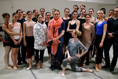 Russian ballet star Irina Kolesnikova (C) surrounded by ballet dancers poses for a picture inside the National Theatre in Belgrade, Serbia, April 21, 2016. REUTERS/Marko Djurica