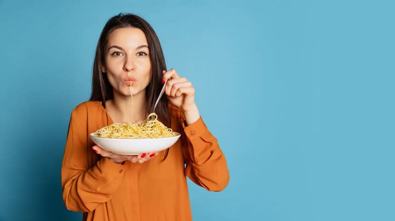 woman slurping pasta