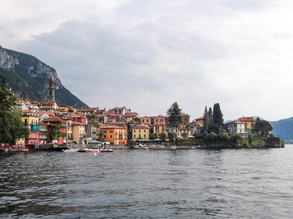 Colorful houses in front of a body of water in Varenna, Italy.