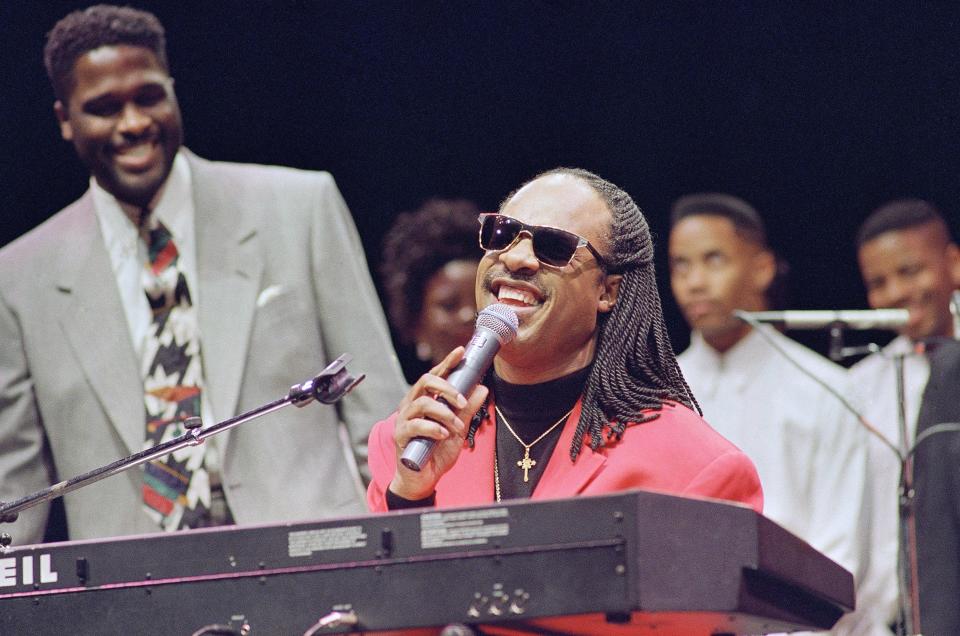 Stevie Wonder sings at a breakfast celebration honoring Martin Luther King in Phoenix on Jan. 15, 1993. Wonder had refused to perform in Arizona because of the lack of a Martin Luther King Jr. holiday.