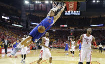 FILE - Los Angeles Clippers' Blake Griffin (32) scores past Houston Rockets' Dwight Howard (12) and Trevor Ariza (1) during the second half in Game 5 of the NBA basketball Western Conference semifinals Tuesday, May 12, 2015, in Houston. Griffin announced his retirement Tuesday, April 16, 2024, after a 14-year career that included six All-Star selections, Rookie of the Year honors and a dunk contest victory. (AP Photo/David J. Phillip, File)